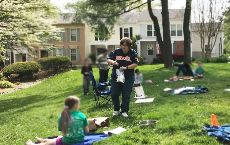 Therea teaching lessons on a lawn in her neighborhood during Covid