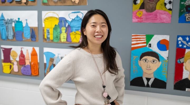 Young Asian female teacher standing smiling